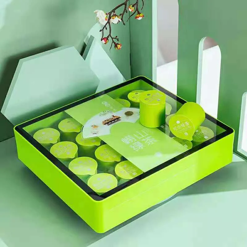 Round cardboard canister in a square plastic box with acrylic clear cover