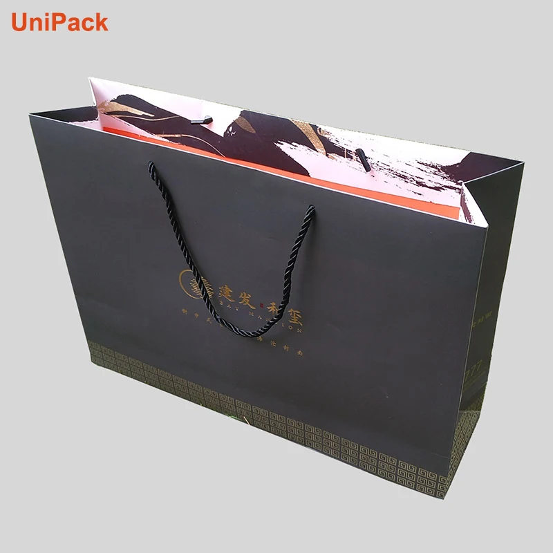 Luxury paper shopbag in white art card with ribbon handles and foil stamp
