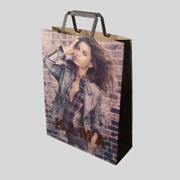 White kraft clothing bag with flat paper handles holding folded garments