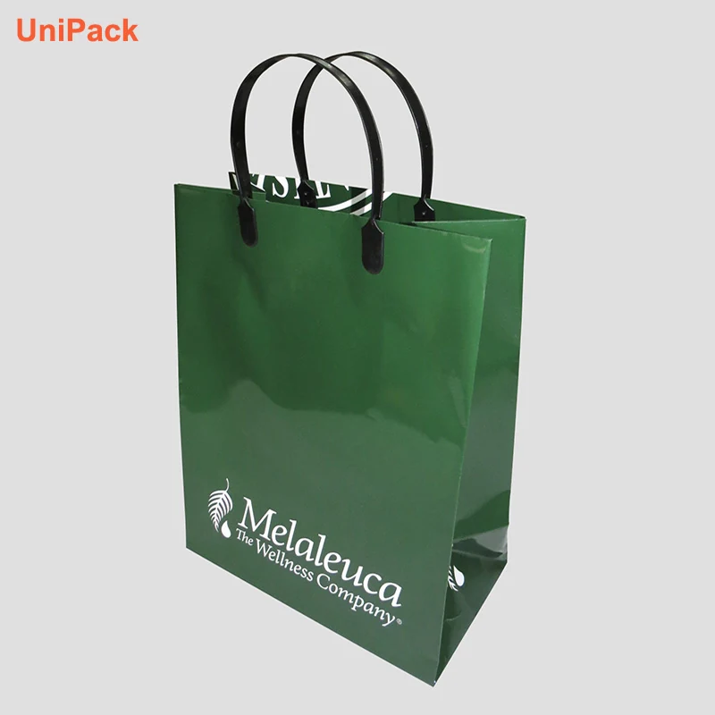 White art card paper bag with plastic handles and colour printed design