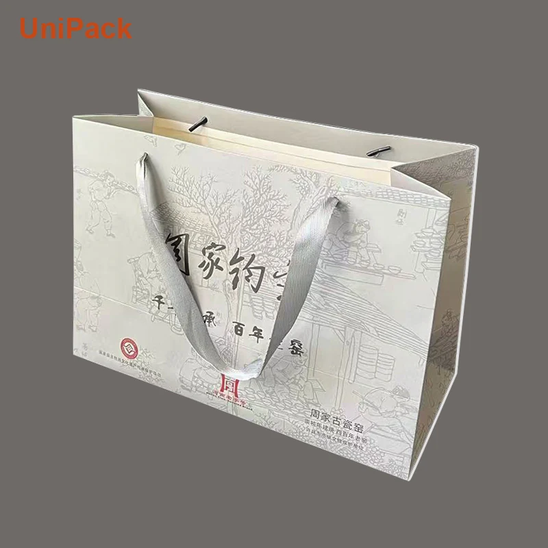 White art card paper shopbag 34x15x24cm with embossed and foil detail