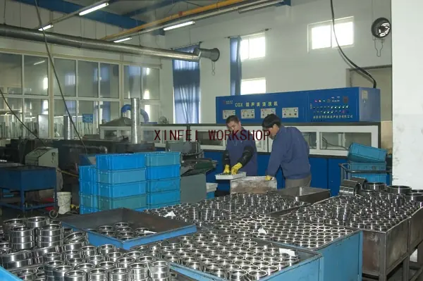 Operators gauging finished rings at the inspection bench