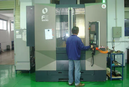 Operator setting a workpiece on a high-precision CNC machining centre