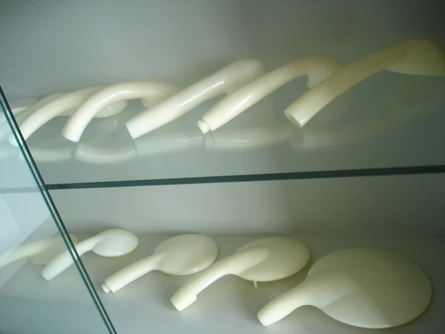 Moulded shower handle bodies resting on an inspection rack