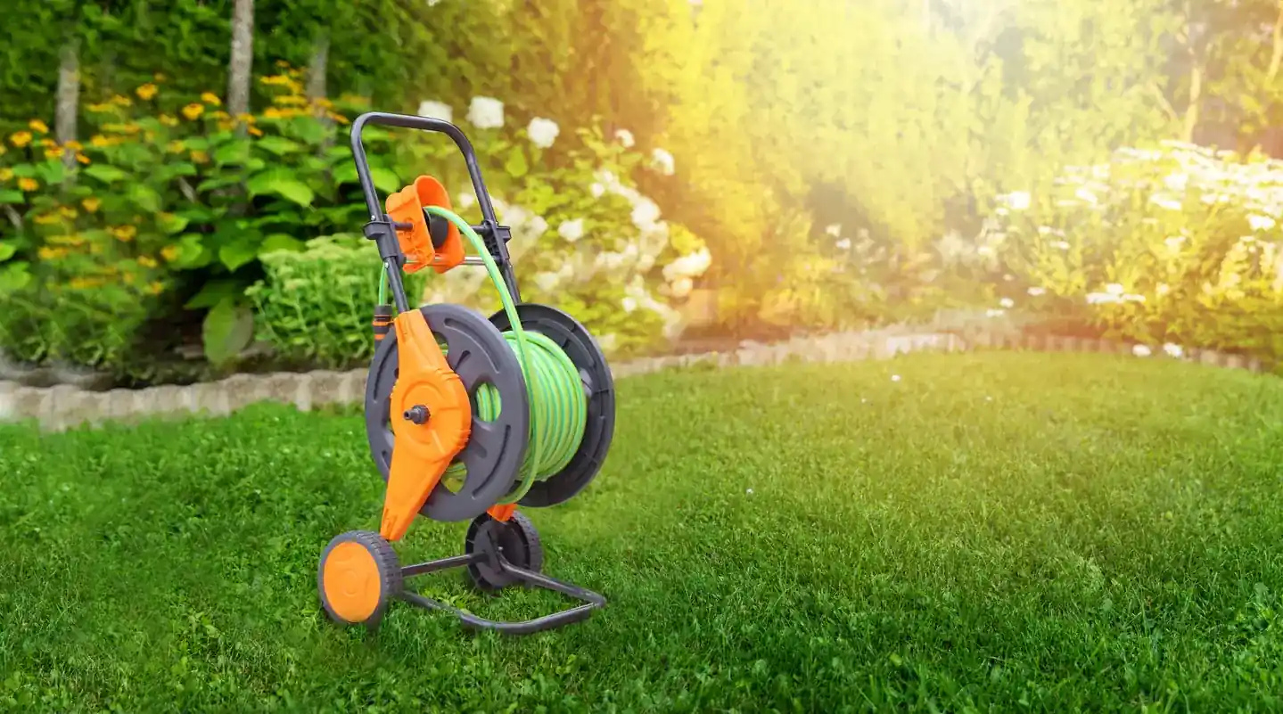 Garden hose cart and watering products on a lawn