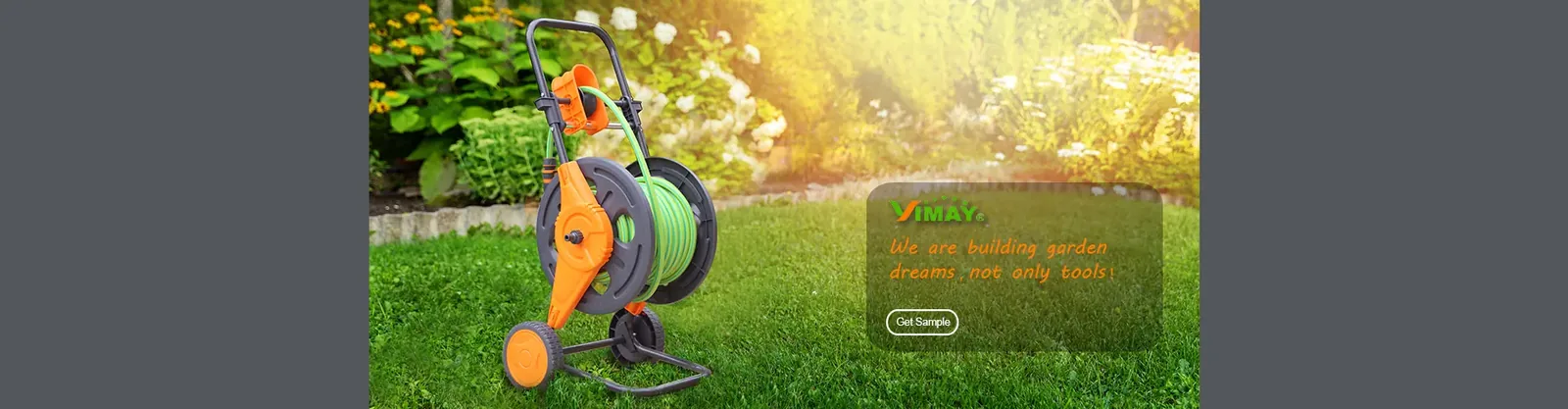 Garden hose cart on a lawn in summer sunlight