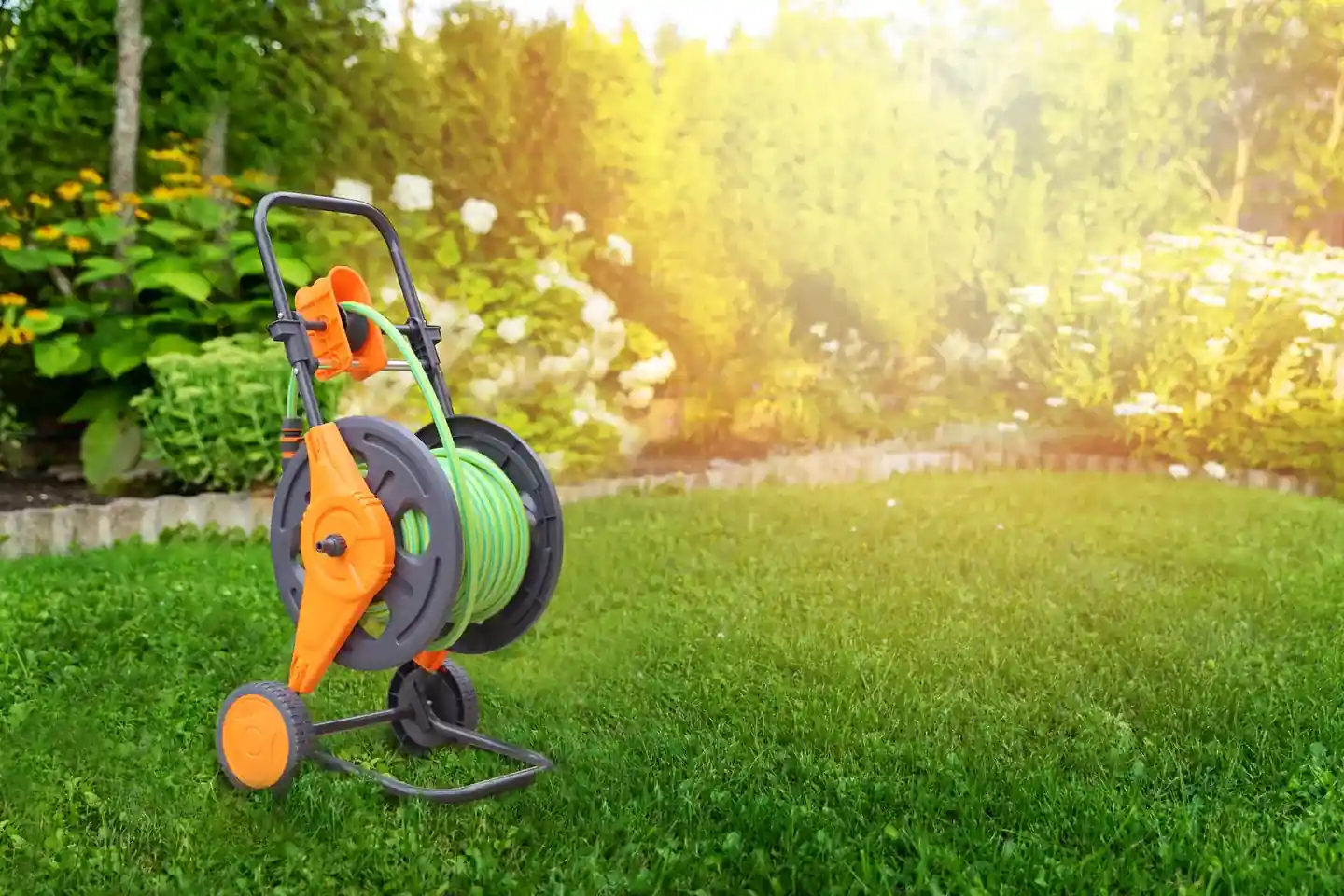 YIMAY two wheel hose cart standing on a sunlit lawn