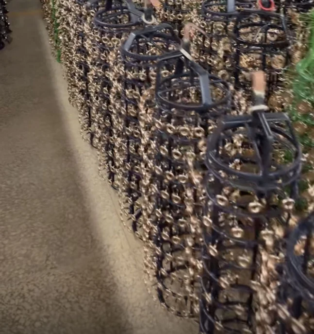 Racks of brass bag hardware loaded for electroplating at the YOUYING Hardware factory
