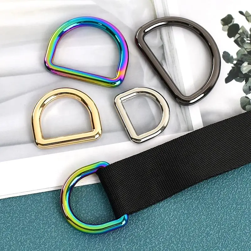 Rainbow, gold, nickel and gunmetal D rings shown with black webbing