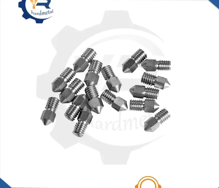 Scattered pile of threaded metallic 3D printer nozzles with pointed tips on a white background