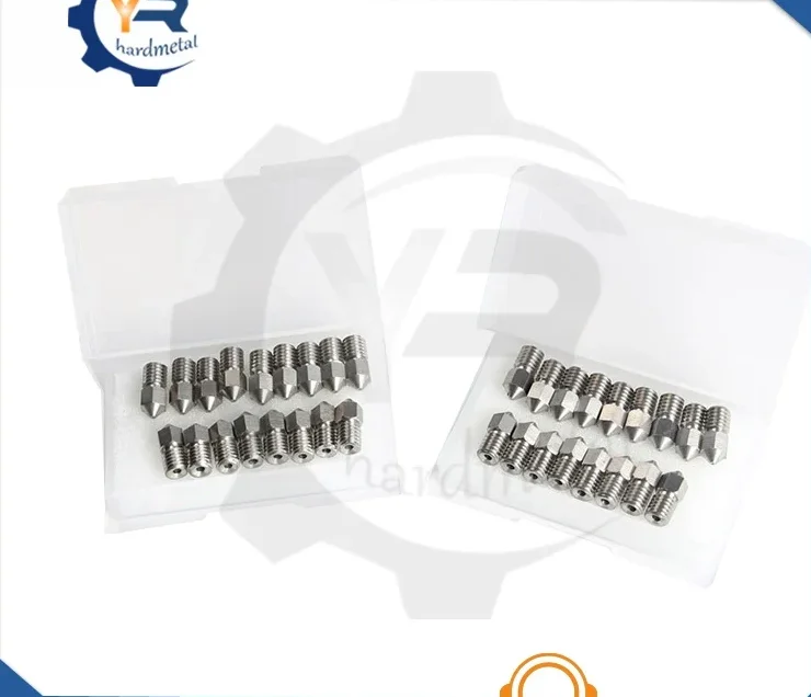 Metallic carbide 3D printer nozzles with threaded bodies and cone tips arranged in two plastic storage boxes