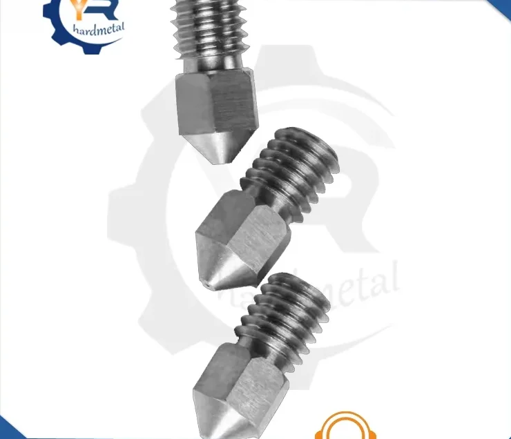 Three threaded metallic nozzle tips with pointed conical ends arranged diagonally on a white background