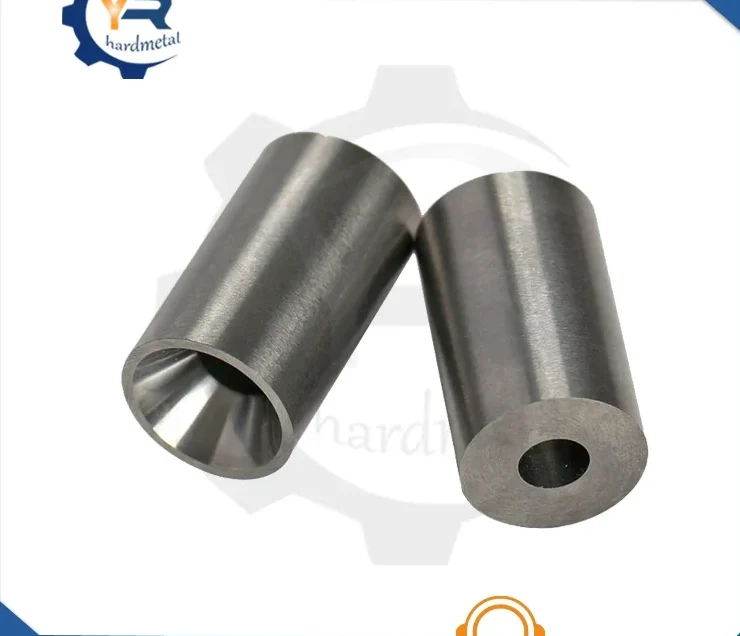 Two polished tungsten carbide nozzle cylinders, one with tapered bore, one with straight through-hole