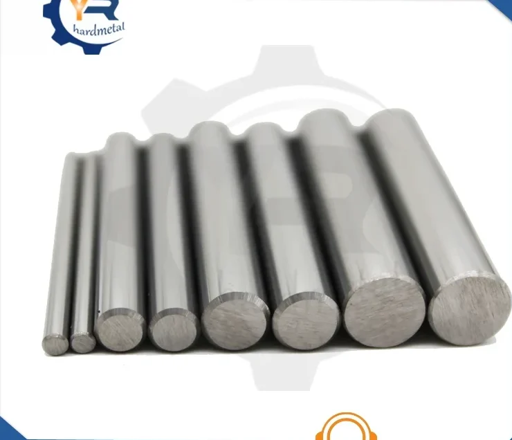Assorted tungsten carbide rods of varying diameters and lengths arranged in a row on a white background