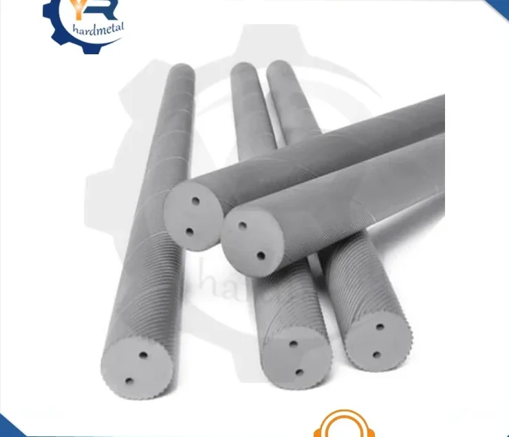 Several gray tungsten carbide rods with helical coolant holes in their end faces, crossed on a white background