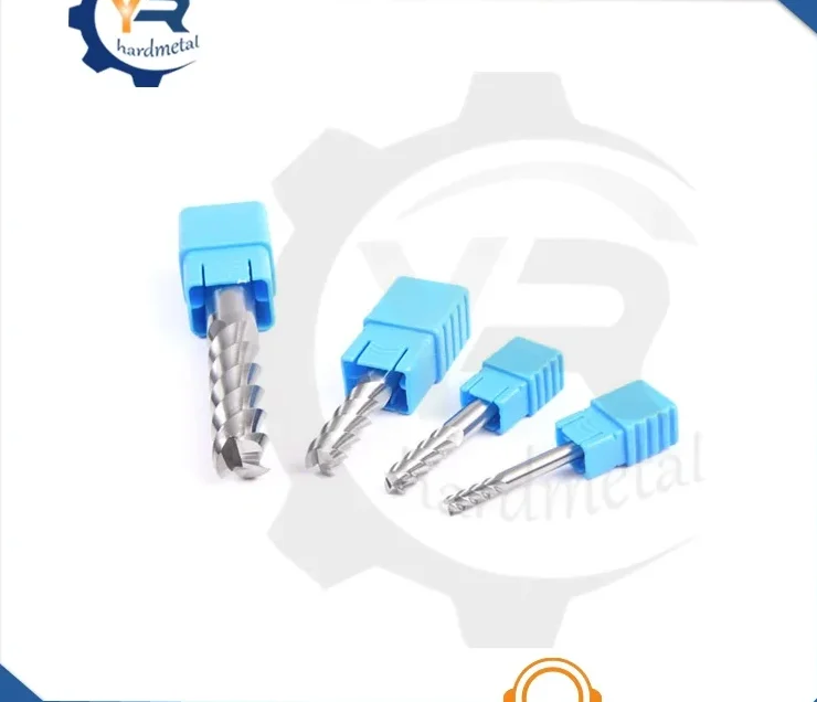 Four carbide end mills with blue protective caps on shanks arranged diagonally on white background