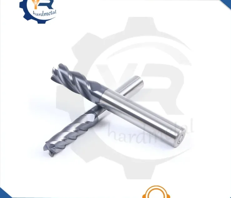 Two carbide round nose end mills with spiral flutes lying crossed on a white background