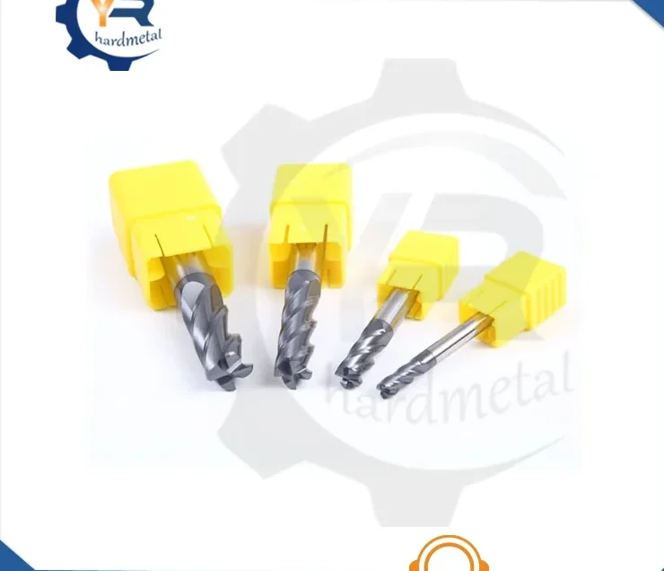 Four tungsten carbide round nose end mills in yellow holders on a white background