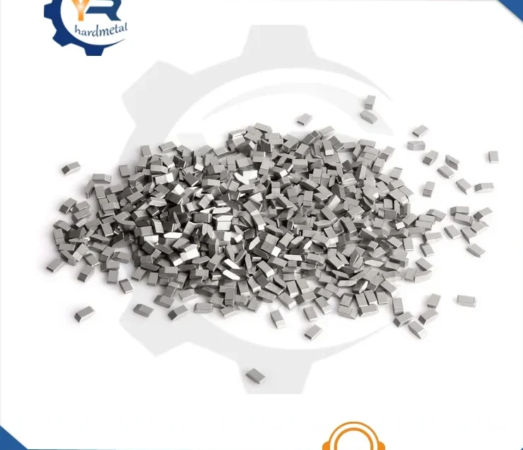 Pile of small rectangular tungsten carbide saw blade tips on a white background with a brand logo overlay