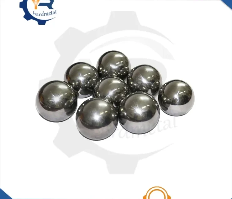 Group of polished silver-gray tungsten carbide balls arranged on a white background