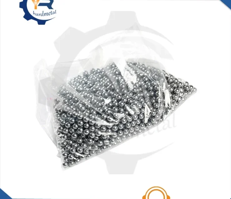 Clear plastic bag filled with small shiny tungsten carbide balls on a white background