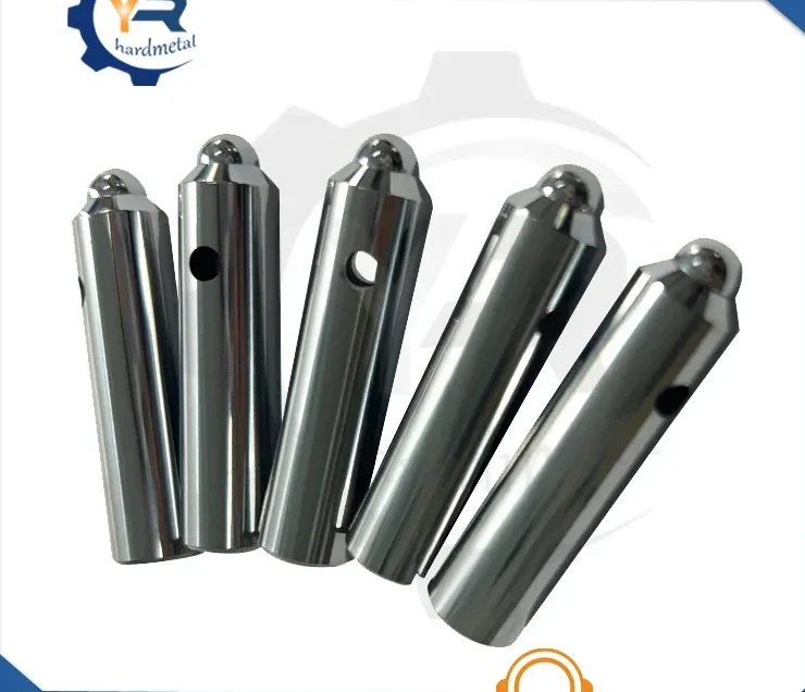 Five polished tungsten carbide pins with domed tips and small cross holes fanned out on a white background