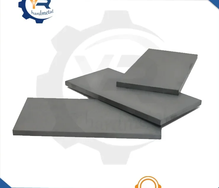 Flat gray tungsten carbide plates stacked at overlapping angles on a white background