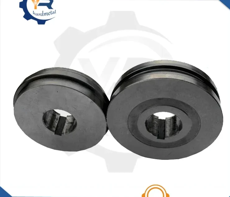 Two dark carbide roll rings with grooved profiles and keyed center bores photographed on a white background