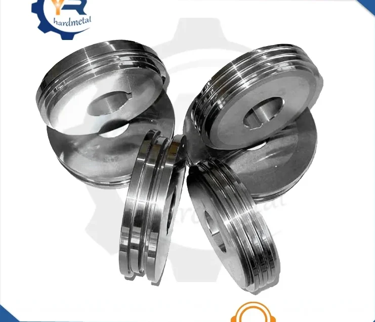 Grooved tungsten carbide roller rings grouped together on a white background