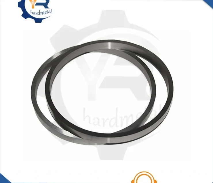 Two gray tungsten carbide seal rings overlapping on a white background
