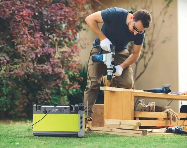 Portable LiFePO4 power station running a power tool at an outdoor worksite
