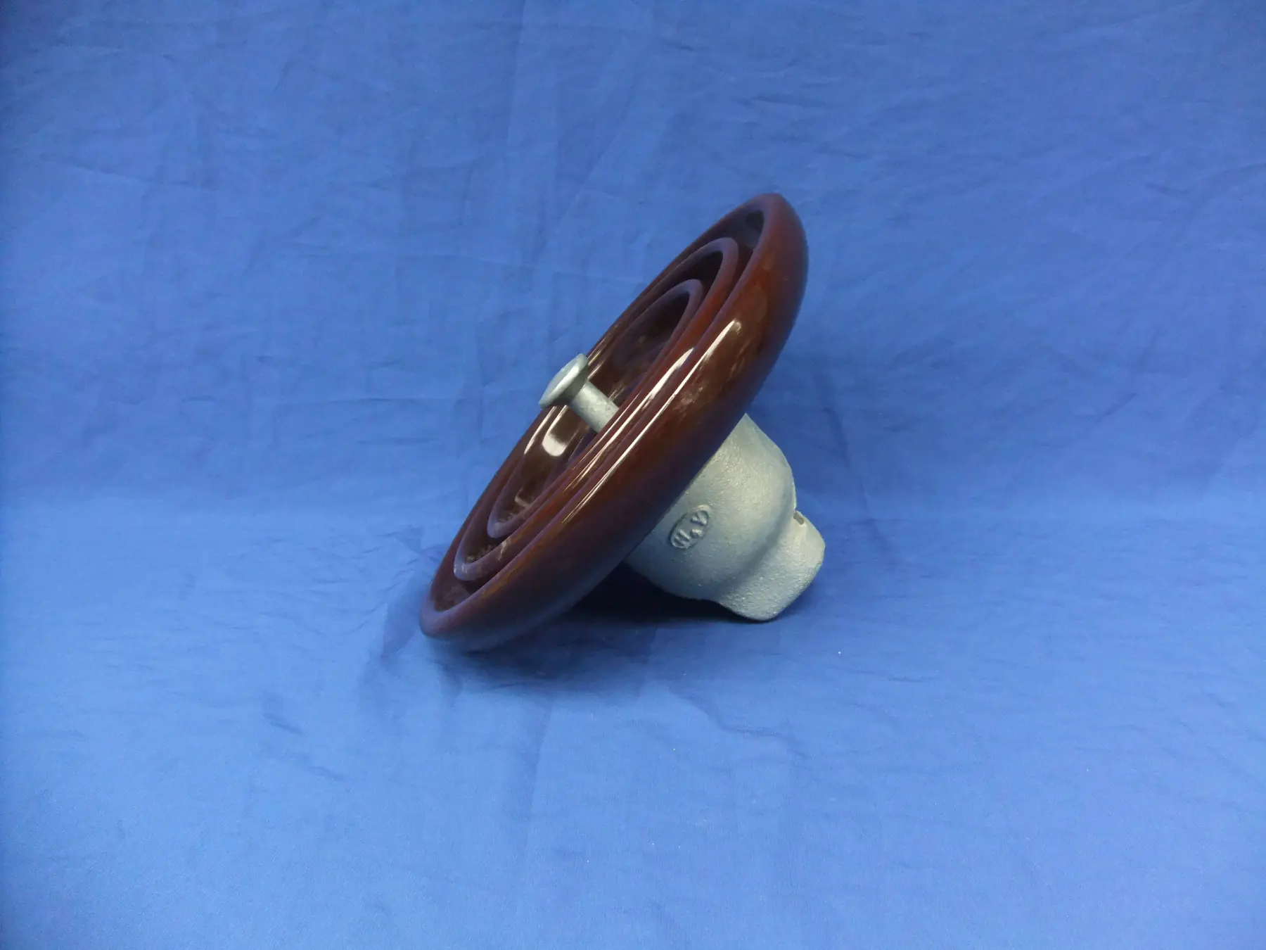 Brown glazed porcelain ANSI suspension disc with galvanized cap and eye