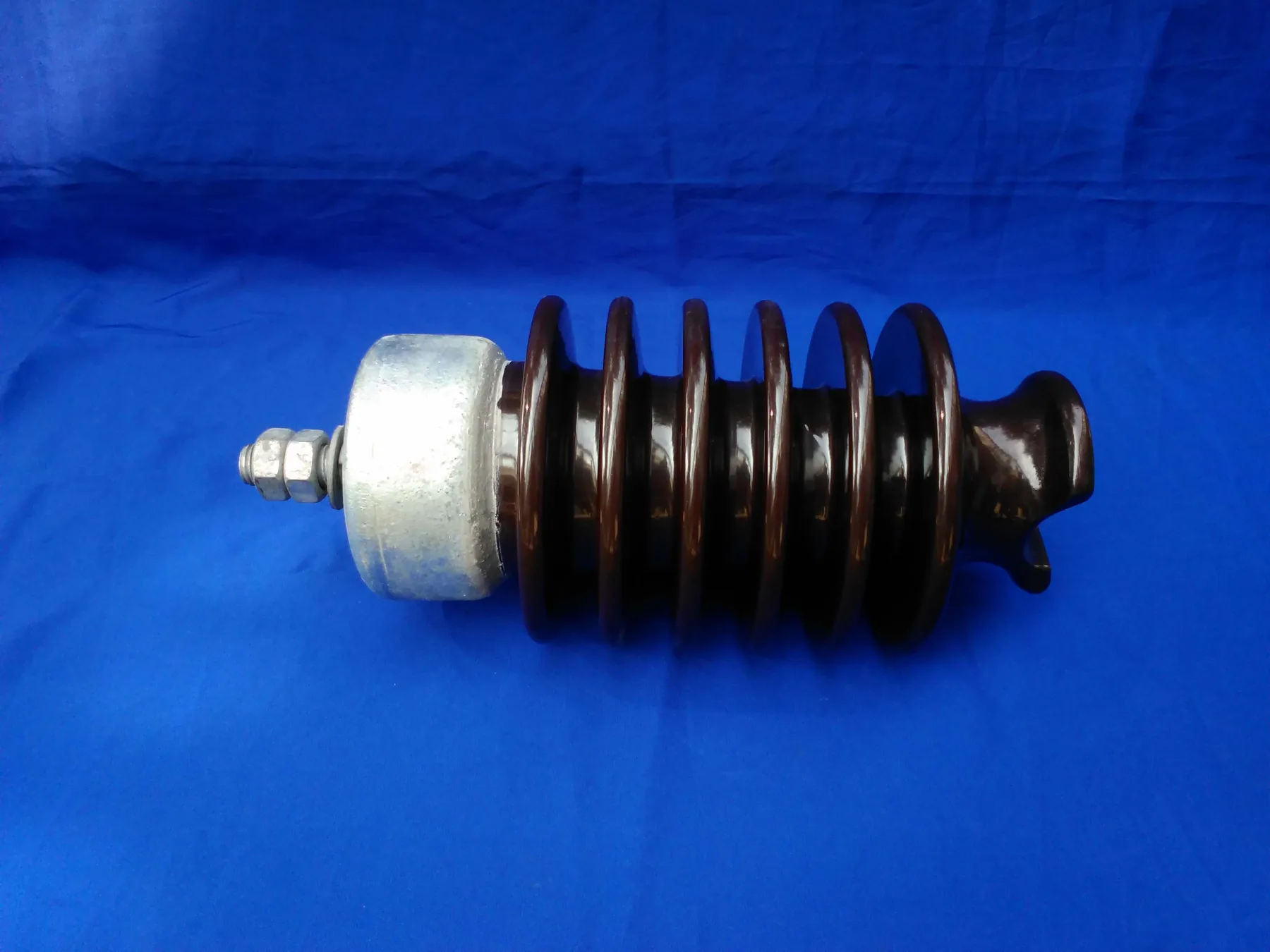 Brown glazed porcelain line post insulator with metal cap