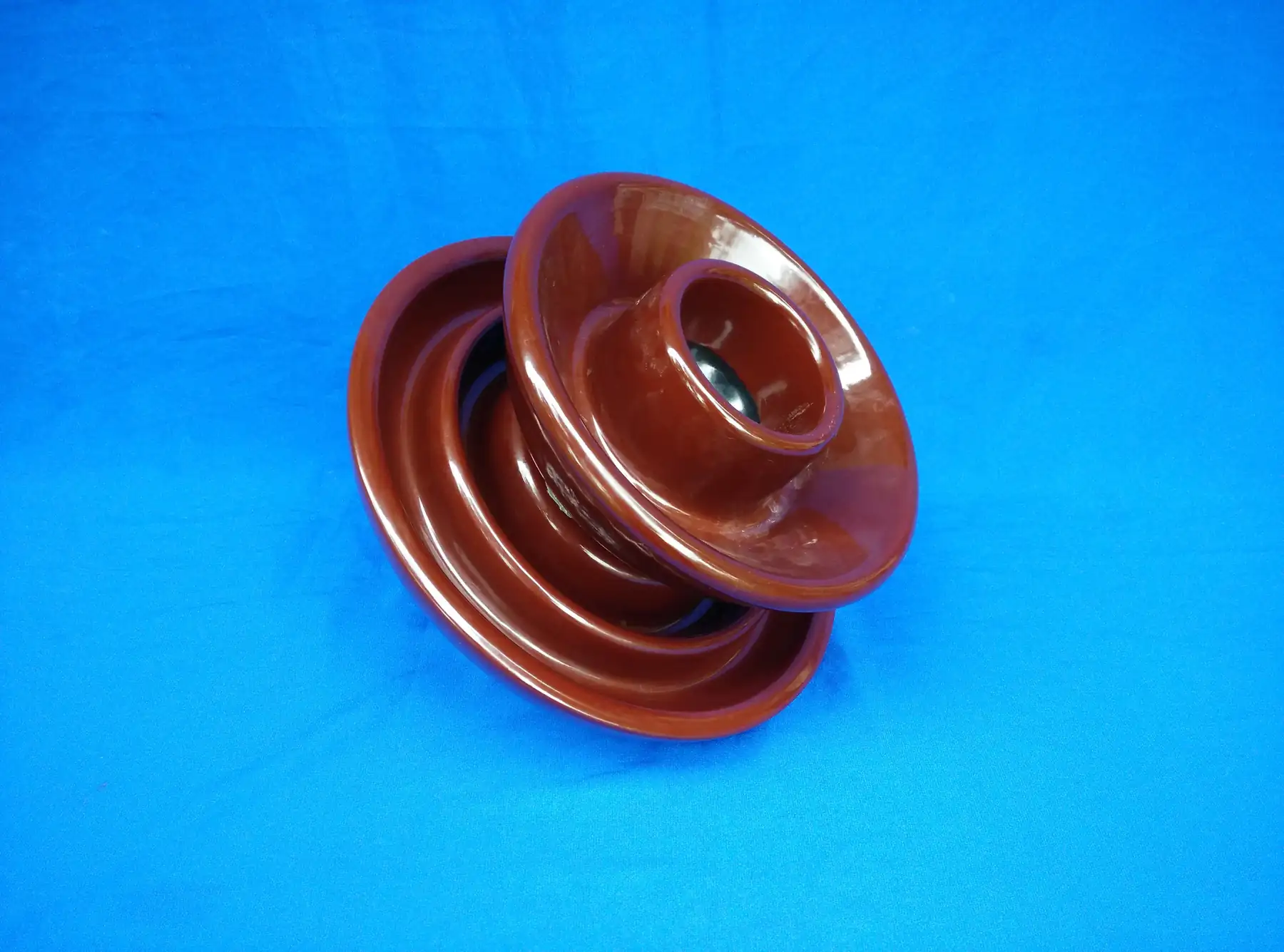 Porcelain pin type insulator showing the glazed shed surface