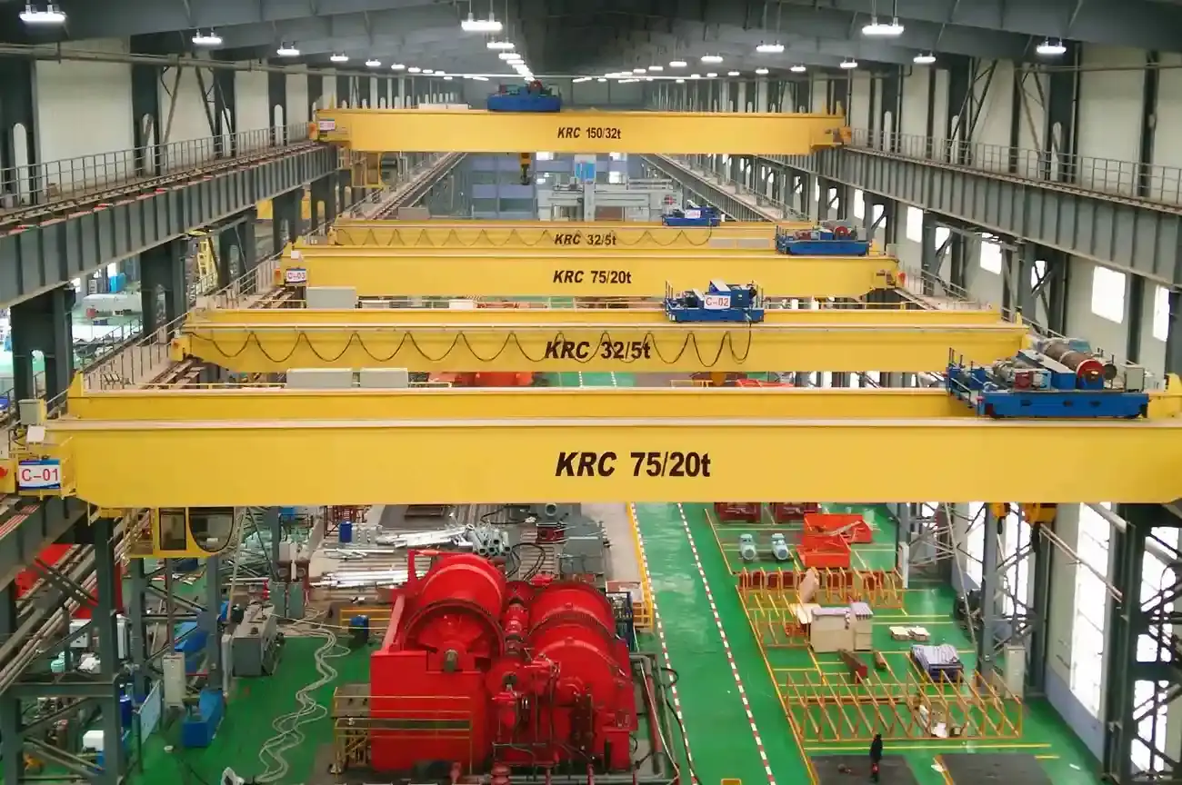 Winch type double girder crane lifting a load at a shipyard workshop