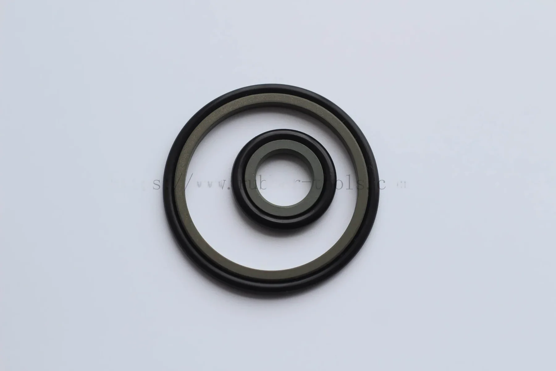 Green rubber O-rings arranged on a light background
