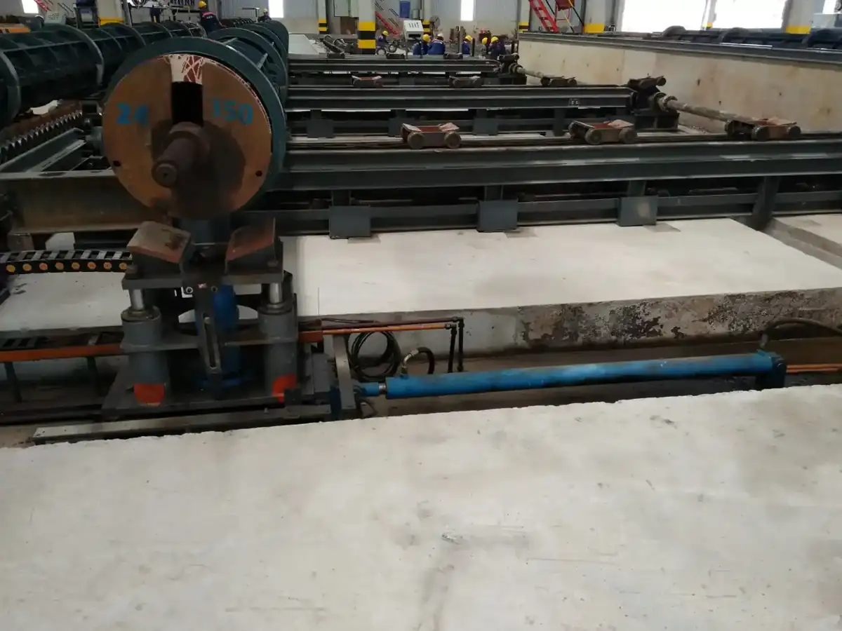 Conveyor bringing moulds out of the steam curing pit.