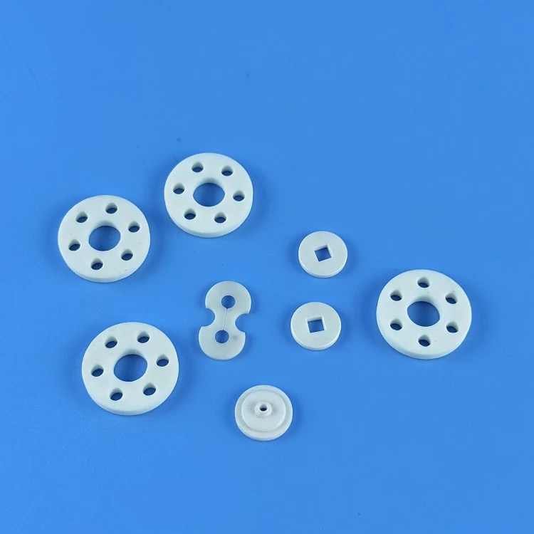 Alumina ceramic discs and rings arranged on a blue background