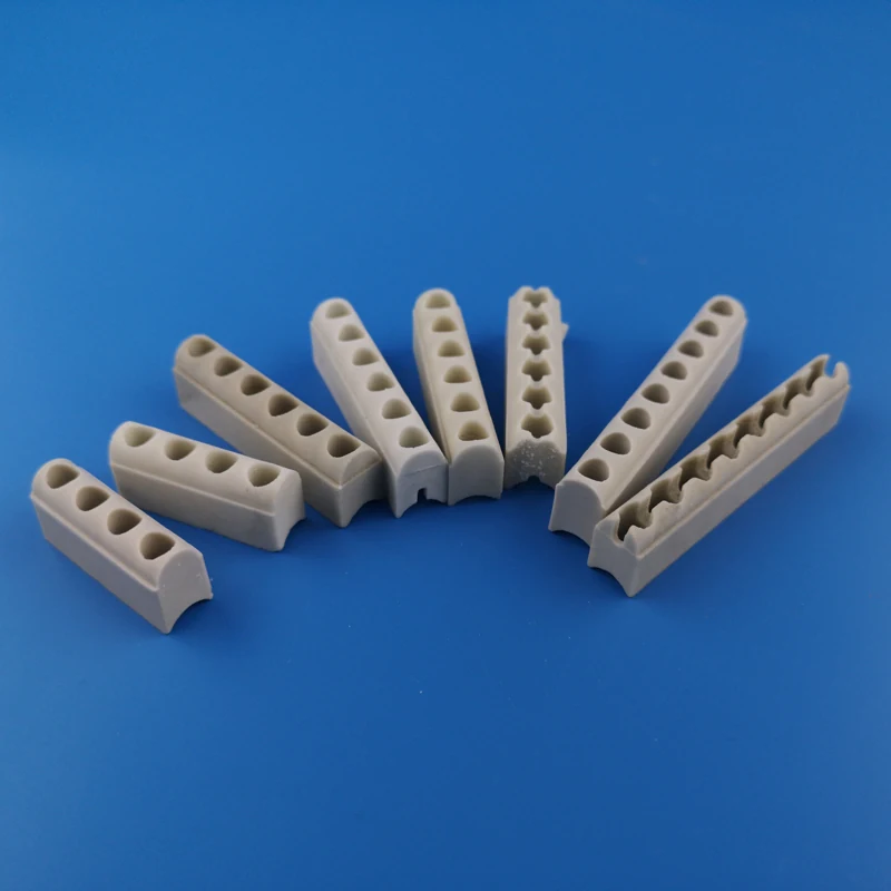 White ceramic heating strips with multiple holes arranged on a blue background