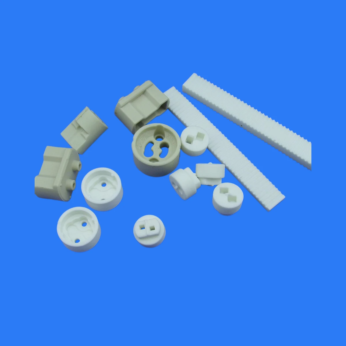 Assorted white alumina ceramic parts including rings plates tubes and blocks