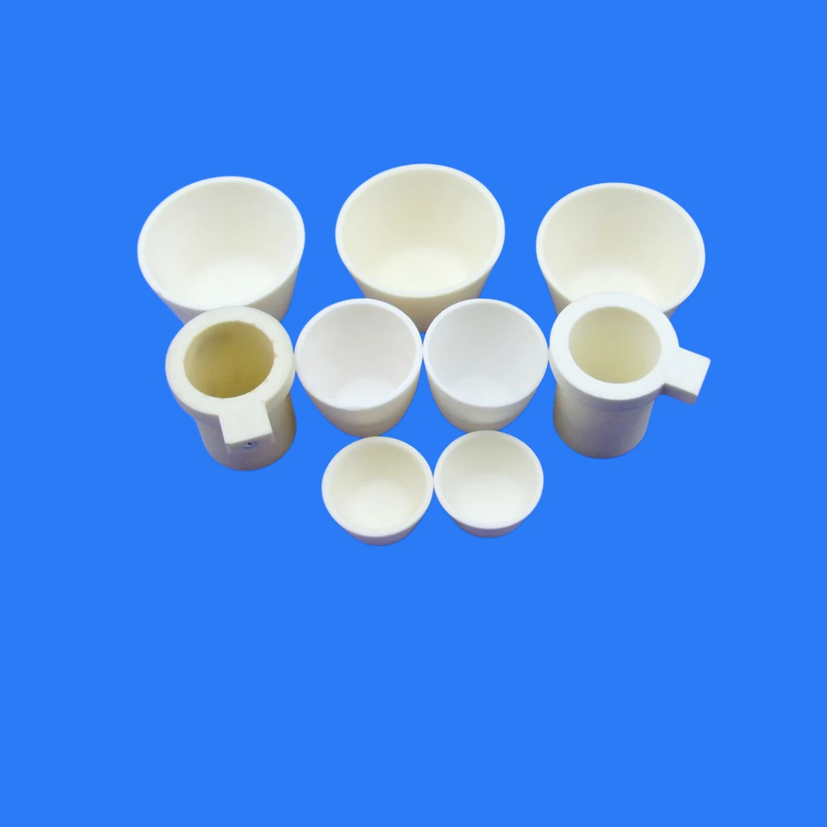 White ceramic cups bushings and crucible shaped parts