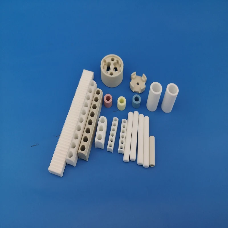 White steatite ceramic insulator strips blocks and beads arranged on a blue background
