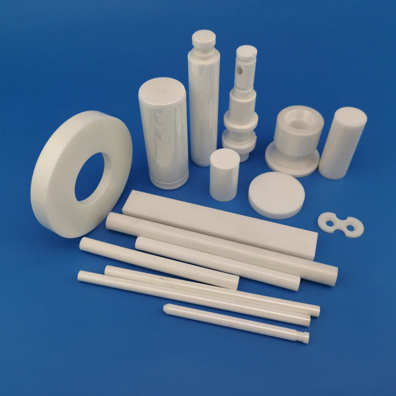 Zirconia ceramic rings rods bushings and sleeves arranged on a blue background