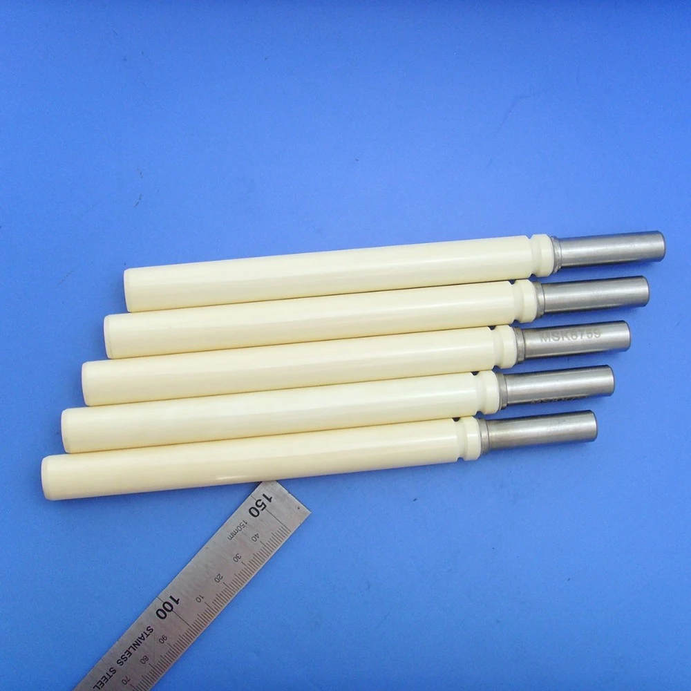 Zirconia ceramic plunger rods of several lengths laid beside a steel rule