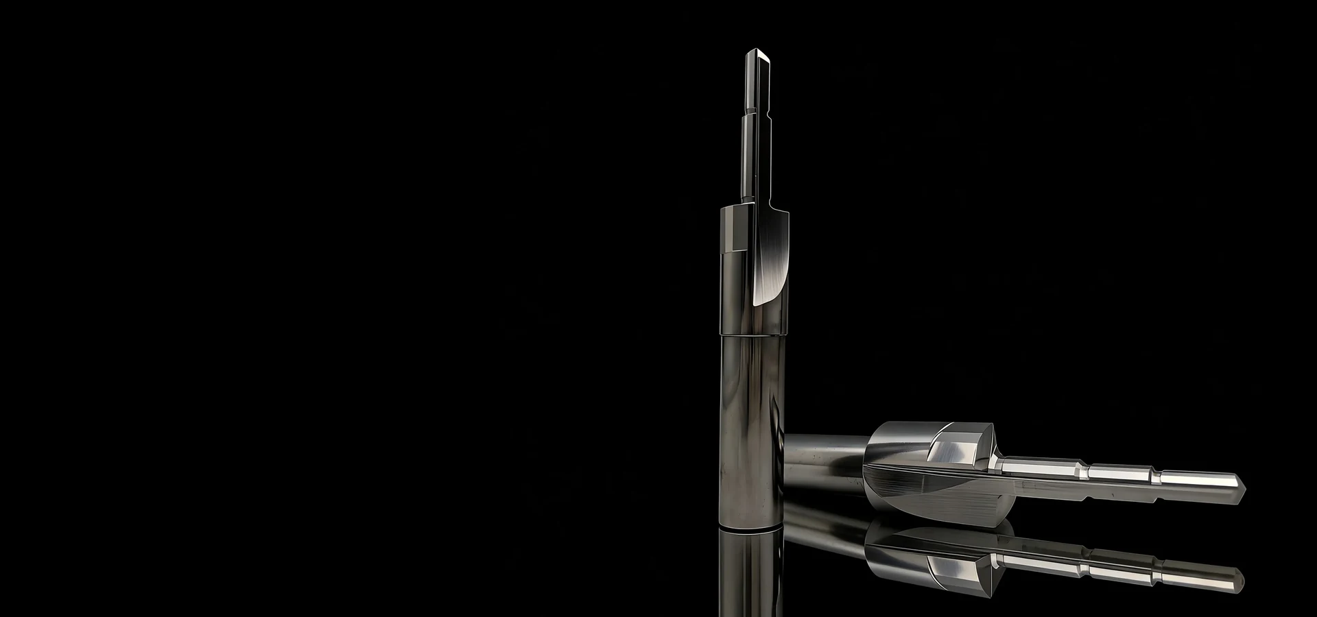 Ground tungsten carbide punches and form tools on a black studio background